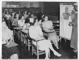 Lena Pecover teaching a group about tuberculosis