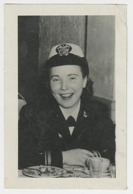 Murdina M. Desmond in military service uniform sitting at dining table